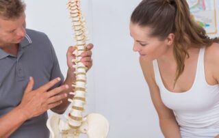man explains herniated discs to a woman